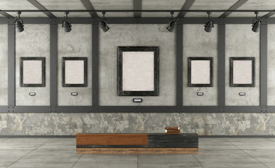 Art gallery in loft with concrete wall and iron elements