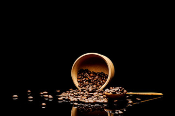 coffe beans  and wood bowl on black background