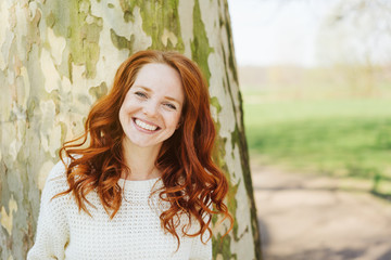 Pretty happy young woman outdoors in a park
