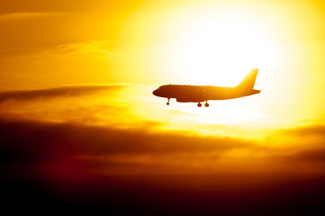 Passenger Aircraft Silhouette With Sun Shining Behind