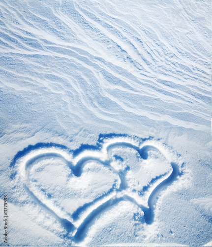 Fototapeta two hearts on to snow