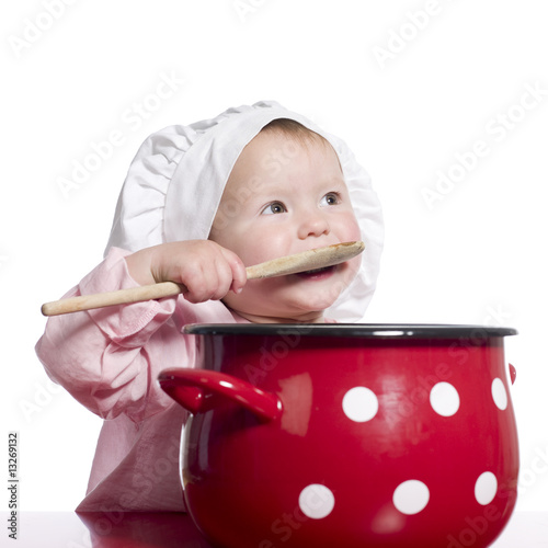 Fototapeta Toddler pretending to cook with a big red pot.