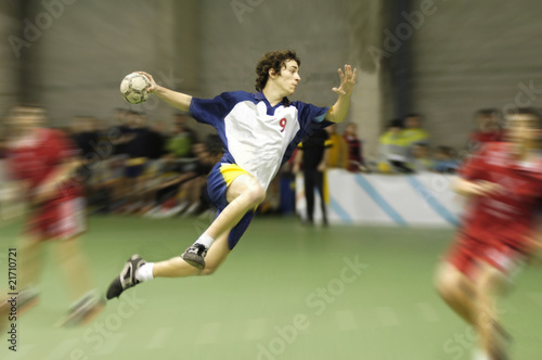 Lacobel young handball player on a match jumping to score a goal