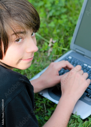 adolescent avec son ordinateur dans l'herbe from Eléonore H, Royalty-free ...