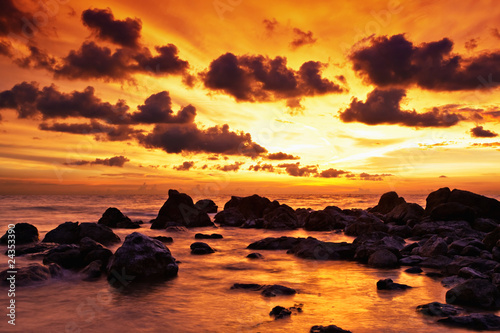 Fototapeta Tropical sunset on the stones beach. Thailand