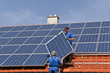 Two workmen are mounting solar