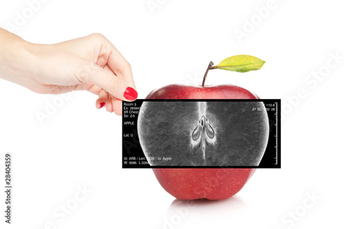 Female doctor holding an x-ray revealing inner view of a red app © Ioannis Pantzi