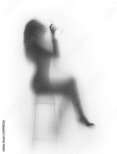 Fototapeta Sexy woman sits on chair and drinks, silhouette