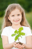Little girl with oak tree seedling