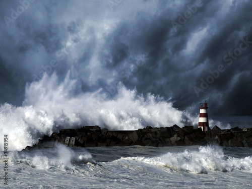 Fototapeta Stormy waves against beacon