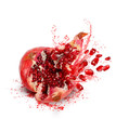 Falling and crack pomegranate with splashes of juice and seeds