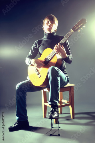 Fototapeta Guitarist musician guitar acoustic playing.