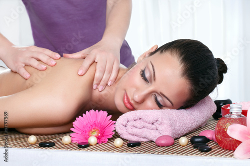 Fototapeta Woman in a day spa getting a deep tissue massage