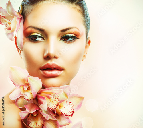 Fototapeta Beautiful Girl With Orchid Flowers. Beauty Woman Face