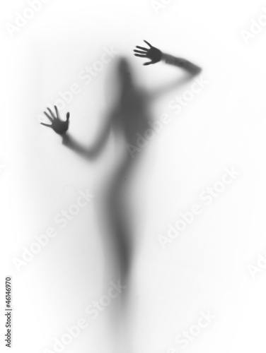 Fototapeta diffuse silhouette of a slim lady, behind a glass surface
