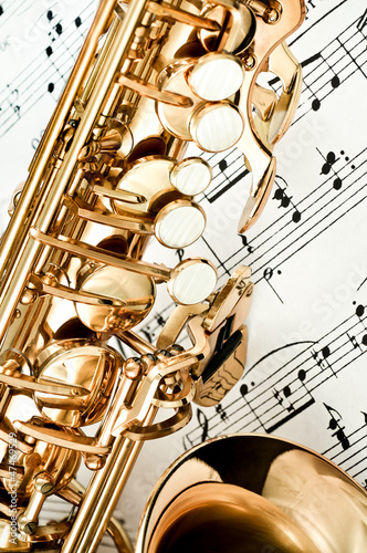  Saxophone keys closeup with score notes in background