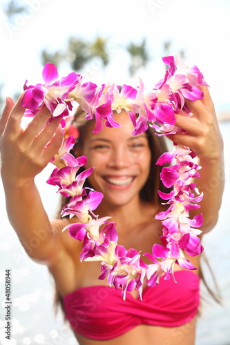 Fototapeta Hawaii woman showing flower lei garland