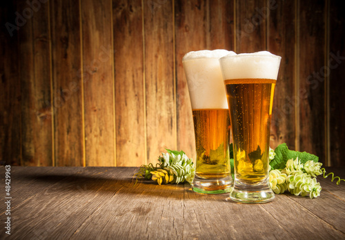 Fototapeta Glass of beers on wooden table