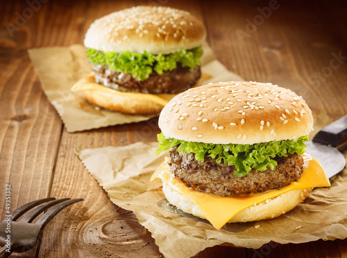 Fototapeta Two cheeseburger with meat, cheese and salad