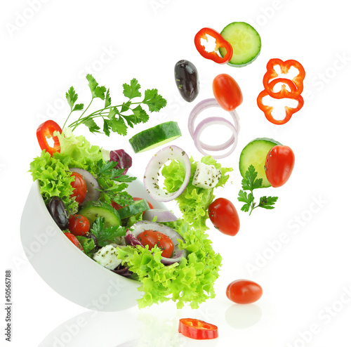 Fototapeta Fresh mixed vegetables falling into a bowl of salad