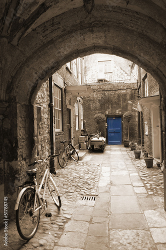  Back alley in London, with bikes, blue door at the end