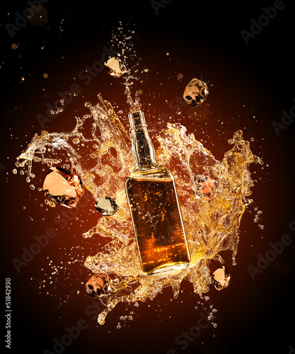 Lacobel Whiskey splashing around bottler on black background