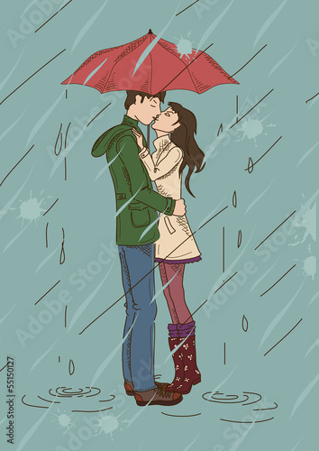 Fototapeta Young couple kissing under an umbrella
