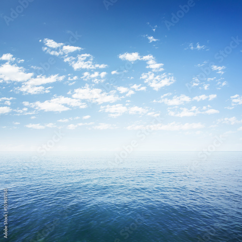 Fototapeta blue sky over sea or ocean water surface