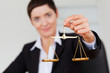 Serious businesswoman holding the justice scale