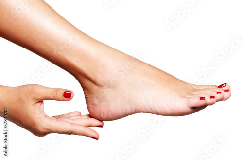 Lacobel Closeup photo of a female feet with beautiful red pedicure