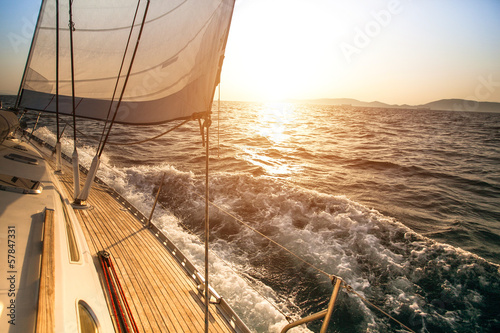 Fototapeta Yacht sailing during sunset. Luxury yachts.