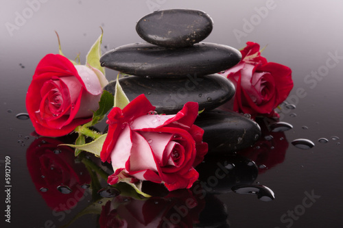 Lacobel Spa stone and rose flowers still life. Healthcare concept.