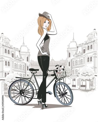 Fototapeta Fashion girl in a hat with a bicycle in the city