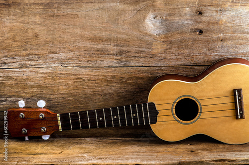  ukulele against a wooden background.
