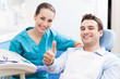 Man giving thumbs up at dentist office