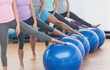 Low section of class with exercise balls at fitness studio