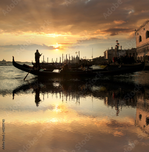 Fototapeta Venice with gondola against beautiful sunset in Italy