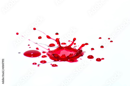 Fototapeta Glossy red liquid droplets (splatters) isolated on white