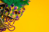 Colorful group of Mardi Gras or venetian mask on yellow