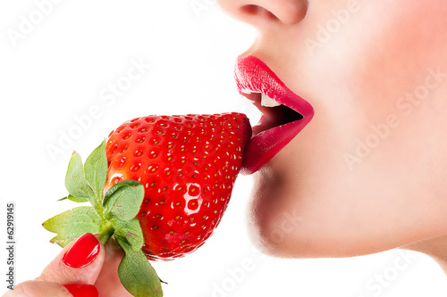 Fototapeta sexy woman eating strawberry, sensual red lips