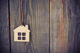 house as symbol on wooden background