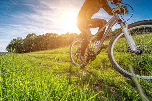 Fototapeta Sport bike, cycling in the beautiful meadow, detail photo,