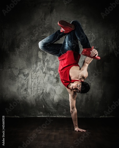 Fototapeta Man dancer showing break-dancing moves