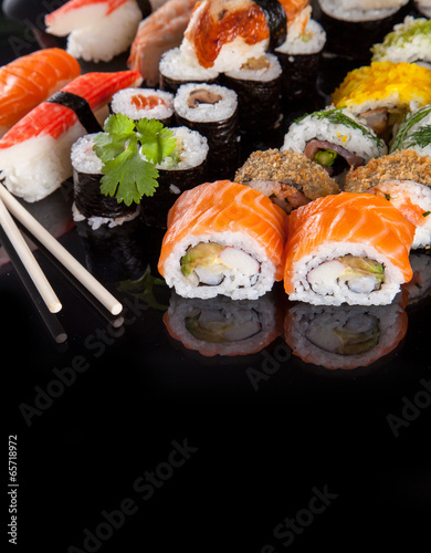  Delicious sushi pieces on black background