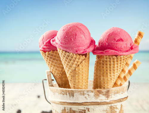 Lacobel Ice cream scoops in cones with blur beach