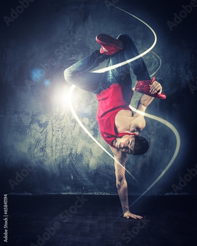 Fototapeta Stylish break-daner dancing with magic beams around him