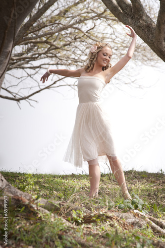  Young beautiful woman dancing ballet outdoors