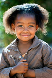 Cute african girl in brown jacket.