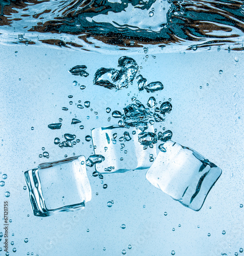 Ice cubes falling under water