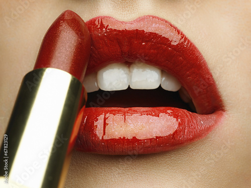 Close-up of woman's lips with bright fashion red glossy makeup. Poster